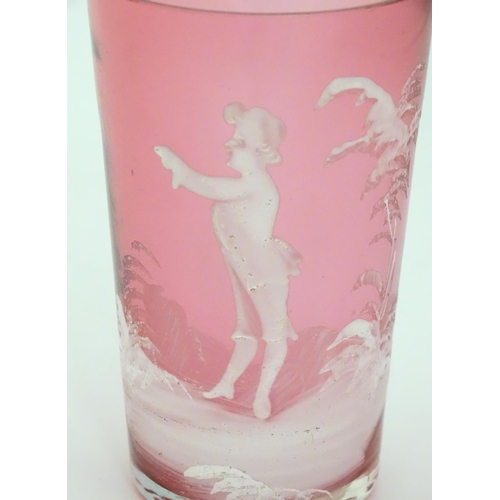 280 - A Cranberry glass beaker with Mary Gregory style white enamel decoration. 4 1/4