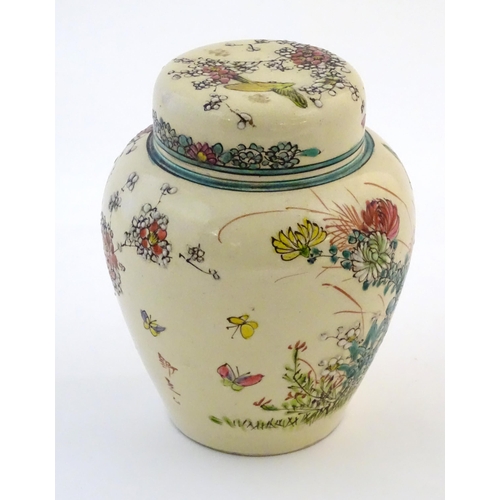 30 - An Oriental ginger jar and cover with inner lid, decorated with flowers and foliage. Possibly Japane... 