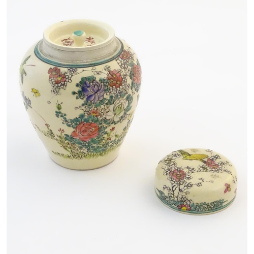 30 - An Oriental ginger jar and cover with inner lid, decorated with flowers and foliage. Possibly Japane... 