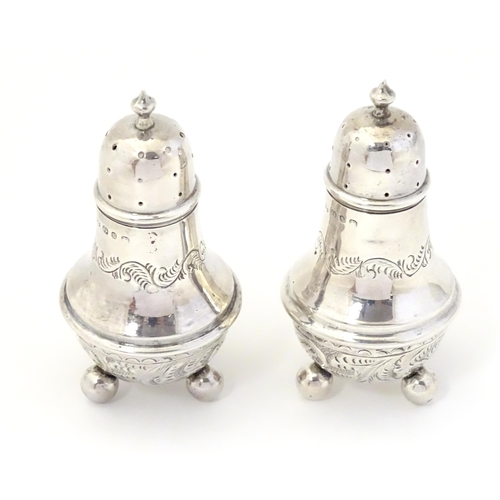 311A - A pair of silver pepperettes, hallmarked Birmingham 1895, maker William Devenport. 3 1/2