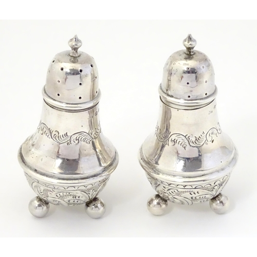 311A - A pair of silver pepperettes, hallmarked Birmingham 1895, maker William Devenport. 3 1/2