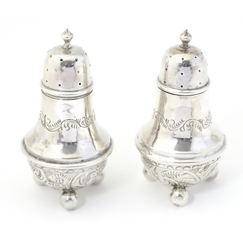 311A - A pair of silver pepperettes, hallmarked Birmingham 1895, maker William Devenport. 3 1/2