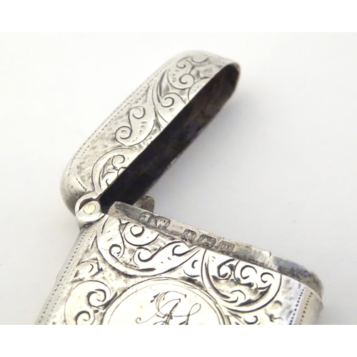 323 - A silver vesta case with engraved decoration, hallmarked Birmingham 1911 maker John Edward Wilmot. 1... 