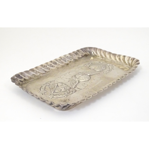 324 - A silver dressing table tray with embossed angel decoration. Hallmarked Birmingham 1902 maker Henry ... 