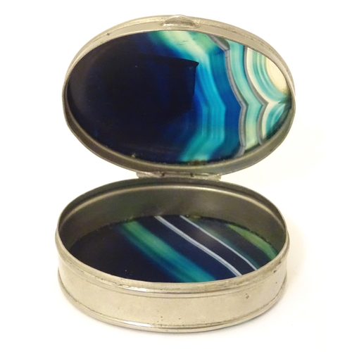 326 - A silver plate pill box of oval form set with blue banded agate to lid and base. Approx 2