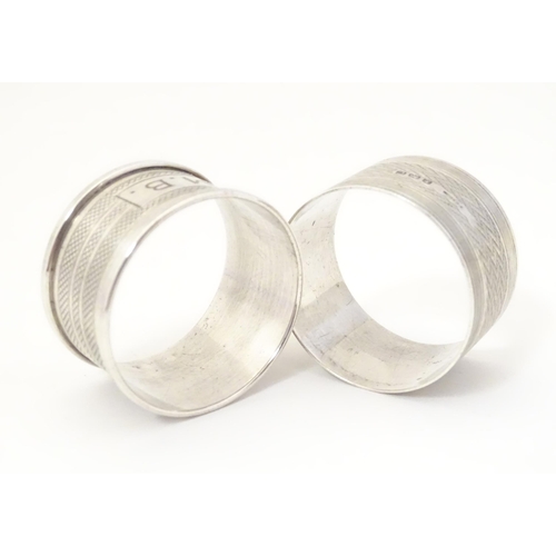 331 - Two silver napkin rings both with engine turned decoration, one hallmarked Birmingham 1927, maker F.... 