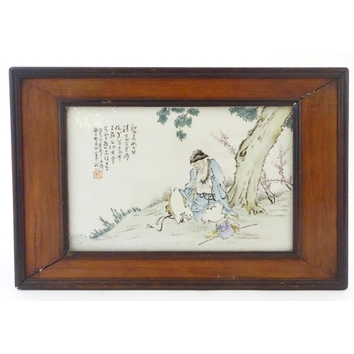 36A - A Chinese porcelain plaque decorated with a seated elder / scholar beneath a tree, with Oriental scr... 