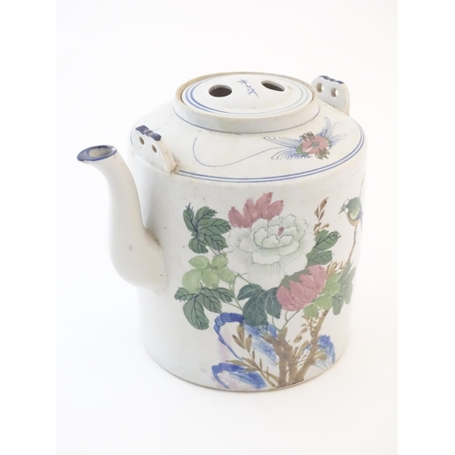 60A - A large Oriental teapot decorated with flowers, foliage and a bird, with scrolling brushwork detail.... 