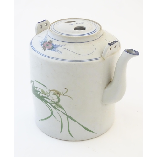 60A - A large Oriental teapot decorated with flowers, foliage and a bird, with scrolling brushwork detail.... 