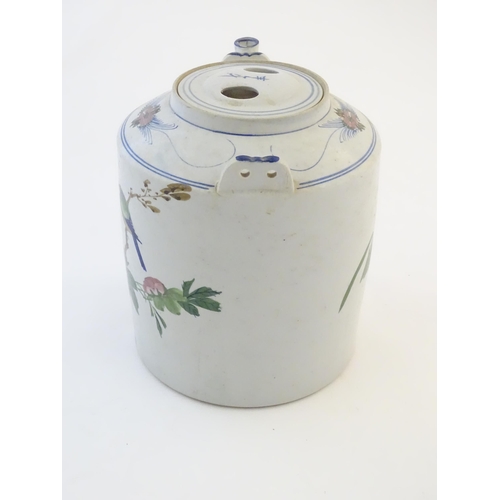 60A - A large Oriental teapot decorated with flowers, foliage and a bird, with scrolling brushwork detail.... 