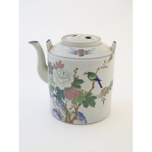 60A - A large Oriental teapot decorated with flowers, foliage and a bird, with scrolling brushwork detail.... 