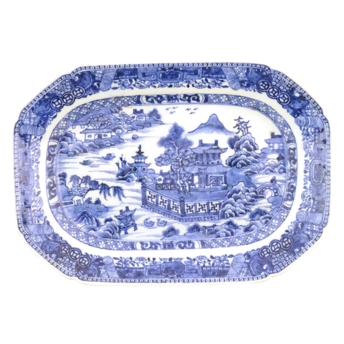 71 - A Chinese blue and white meat plate / platter depicting a landscape scene with mountains, pagodas, t... 