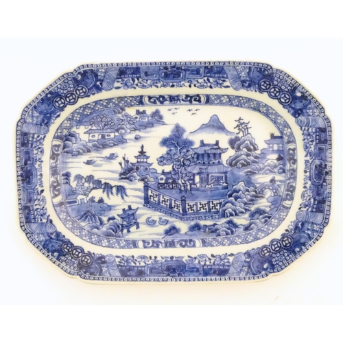 71 - A Chinese blue and white meat plate / platter depicting a landscape scene with mountains, pagodas, t... 