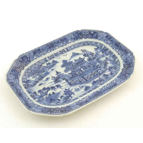 71 - A Chinese blue and white meat plate / platter depicting a landscape scene with mountains, pagodas, t... 