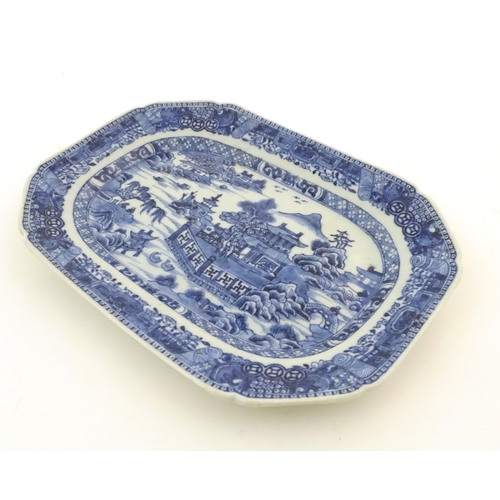 71 - A Chinese blue and white meat plate / platter depicting a landscape scene with mountains, pagodas, t... 