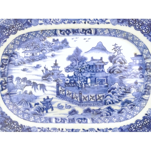 71 - A Chinese blue and white meat plate / platter depicting a landscape scene with mountains, pagodas, t... 