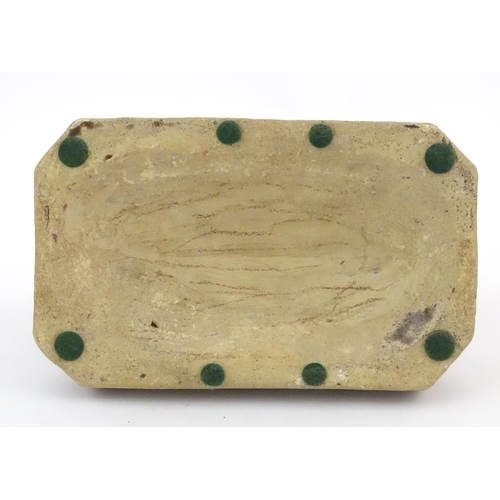 76 - A salt glazed pottery model of a dog on a rectangular plinth. Approx. 5 3/4