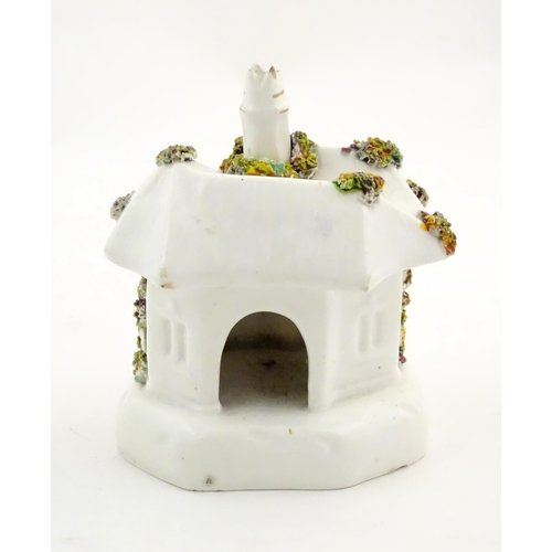 79 - A Staffordshire pottery pastille burner modelled as a cottage, decorated with encrusted flowers. App... 