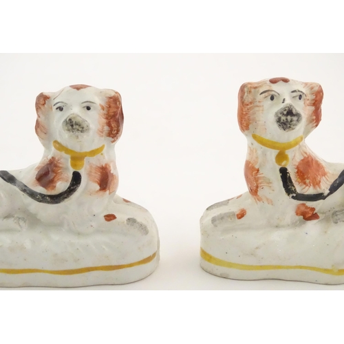 80 - A pair of Victorian Staffordshire pottery seated spaniel dogs. Approx. 2 3/4