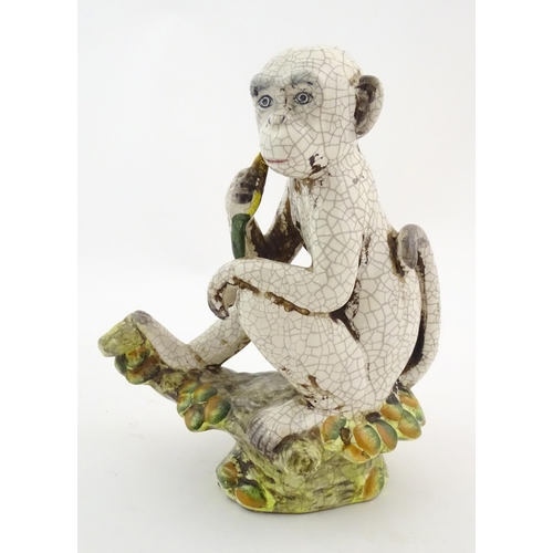 86 - An Oriental style model of a monkey with a banana seated on a branch. Approx. 10 1/2