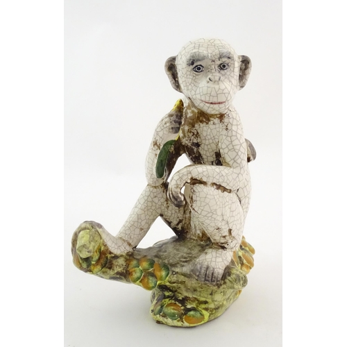 86 - An Oriental style model of a monkey with a banana seated on a branch. Approx. 10 1/2