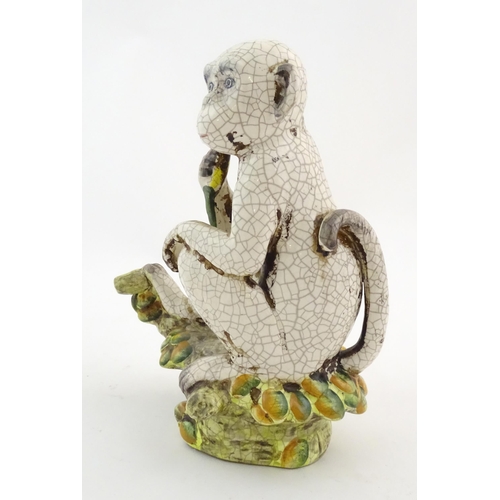 86 - An Oriental style model of a monkey with a banana seated on a branch. Approx. 10 1/2