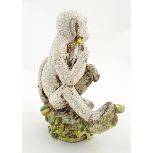 86 - An Oriental style model of a monkey with a banana seated on a branch. Approx. 10 1/2