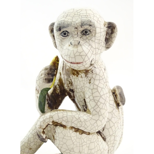 86 - An Oriental style model of a monkey with a banana seated on a branch. Approx. 10 1/2