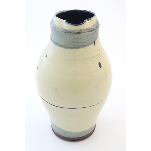 90 - A studio pottery jug with drip and brushwork decoration. Indistinctly signed under. Approx. 11 1/4