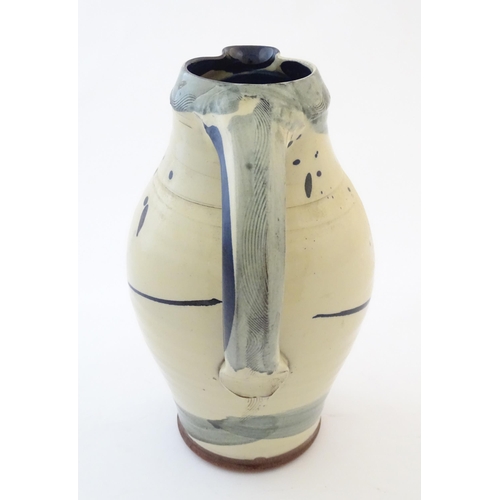 90 - A studio pottery jug with drip and brushwork decoration. Indistinctly signed under. Approx. 11 1/4