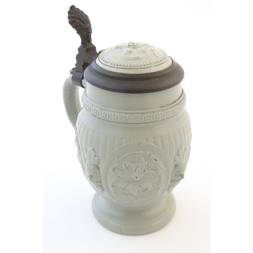 95 - A Villeroy & Boch stoneware stein with moulded foliate decoration. Marked under. Approx. 7