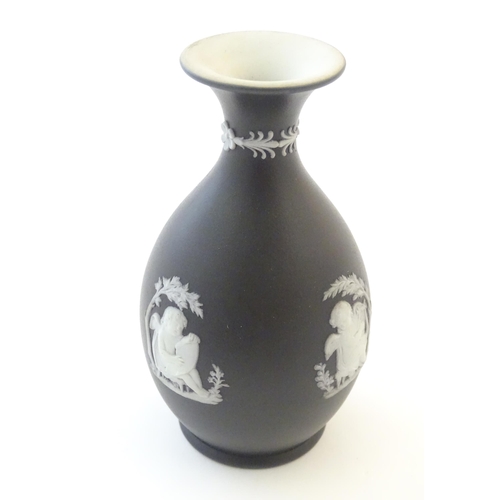 97 - A small Wedgwood Etruria black jasperware vase decorated with classical figures, putti etc. Impresse... 