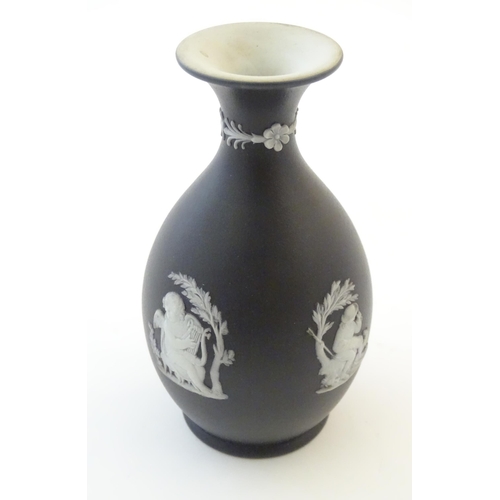 97 - A small Wedgwood Etruria black jasperware vase decorated with classical figures, putti etc. Impresse... 