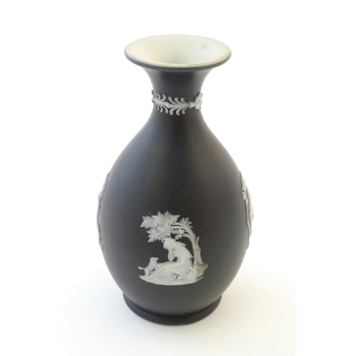 97 - A small Wedgwood Etruria black jasperware vase decorated with classical figures, putti etc. Impresse... 