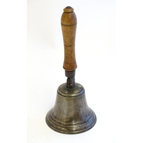 1189 - A 20thC hand bell with turned fruitwood handle with banded detail. Approx. 12 1/2