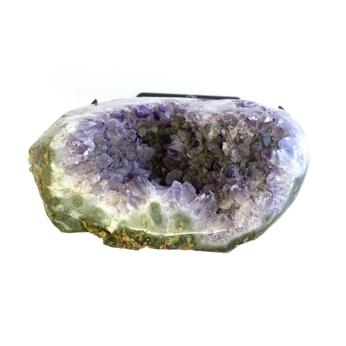 1207 - An amethyst crystal geode with polished edge. Mounted on a stand. Amethyst approx. 7 3/4