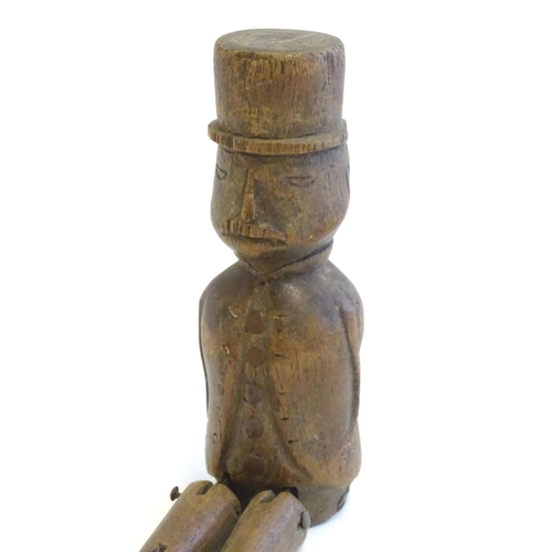 1208 - A 19thC folk art carved wooden naive model of a gentleman wearing a top hat, with articulated legs. ... 