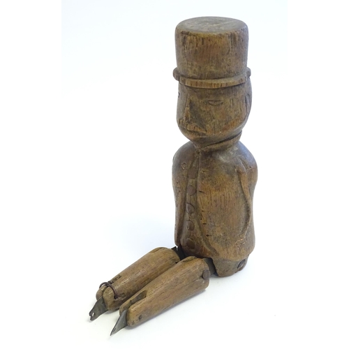 1208 - A 19thC folk art carved wooden naive model of a gentleman wearing a top hat, with articulated legs. ... 