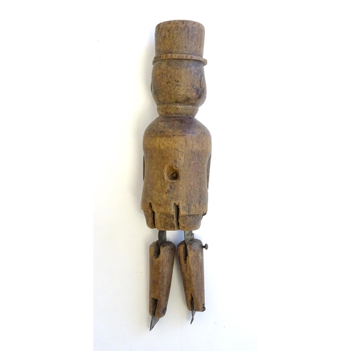 1208 - A 19thC folk art carved wooden naive model of a gentleman wearing a top hat, with articulated legs. ... 