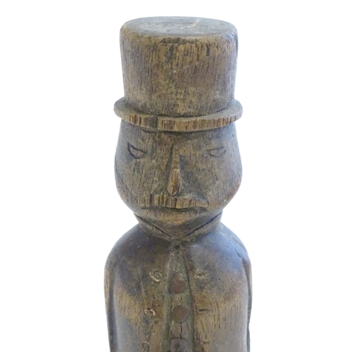 1208 - A 19thC folk art carved wooden naive model of a gentleman wearing a top hat, with articulated legs. ... 