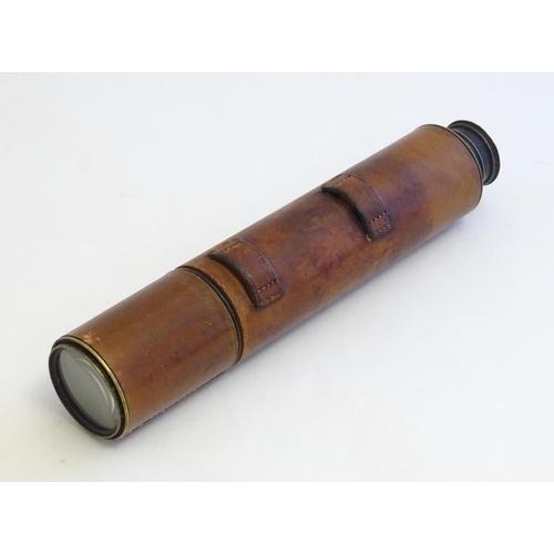 1209 - An early to mid 20thC three-drawer telescope with leather cover and blacked brass finish, stamped J.... 