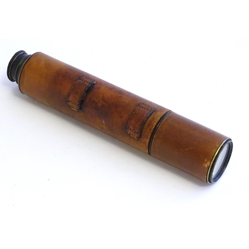 1209 - An early to mid 20thC three-drawer telescope with leather cover and blacked brass finish, stamped J.... 