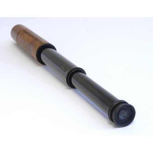 1209 - An early to mid 20thC three-drawer telescope with leather cover and blacked brass finish, stamped J.... 