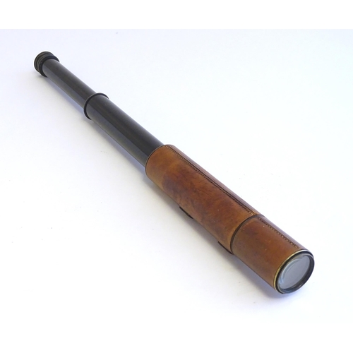 1209 - An early to mid 20thC three-drawer telescope with leather cover and blacked brass finish, stamped J.... 