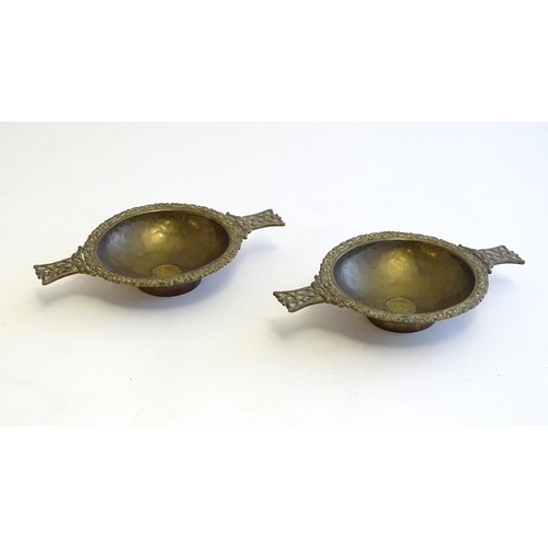 1215 - A pair of Scottish brass quaich with Celtic decoration and inset 1943 threepence coin. Approx. 7 3/4... 