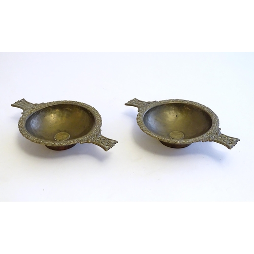 1215 - A pair of Scottish brass quaich with Celtic decoration and inset 1943 threepence coin. Approx. 7 3/4... 