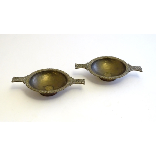 1215 - A pair of Scottish brass quaich with Celtic decoration and inset 1943 threepence coin. Approx. 7 3/4... 