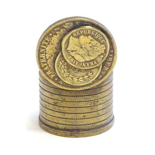 1230 - A 20thC Continental cast inkwell modelled as stacked coins, with applied French coins to top. Approx... 