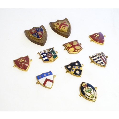 1232 - A collection of gilt metal enamelled collegiate insignia / badges, to include Keble College Oxford, ... 