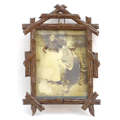 1248 - A 20thC carved wooden photograph frame in the black forest style. Approx. 9